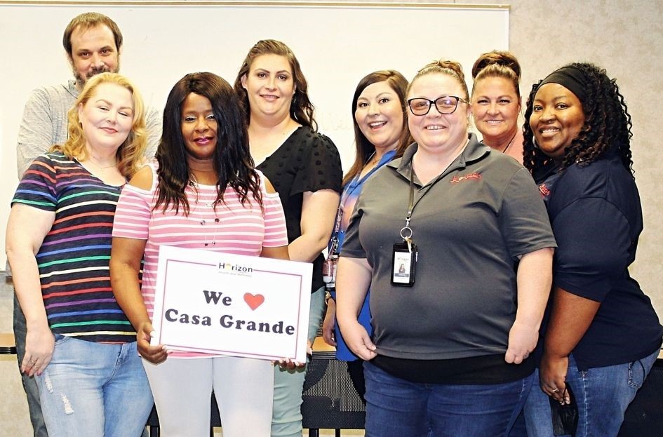 The Horizon Health and Wellness staff at the Casa Grande Clinic holding a "We love Casa Grande" sign.